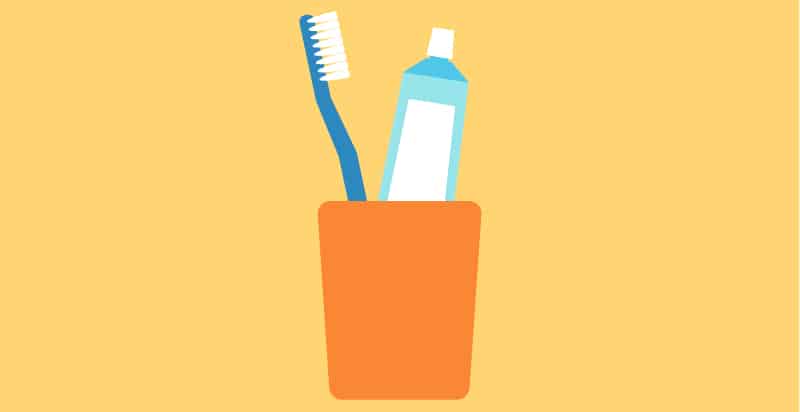 Drawing of a royal blue toothbrush and aqua blue toothpaste tube in an orange cup against a yellow background