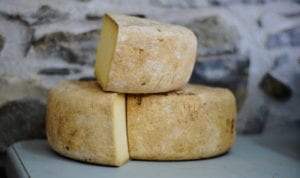 Closeup of 3 big chunks of pale yellow cheese that promotes strong enamel